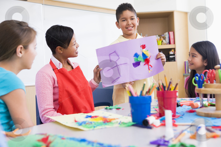 To use this stock image in your creative project, please select the size you need over to the right and click the "Add to Cart" button.
Your downloaded image will come with the Cutcaster watermark removed so don’t worry about the watermark you see on this page. Elementary school art class stock photo, Elementary school art class with teacher by Monkey Business Images