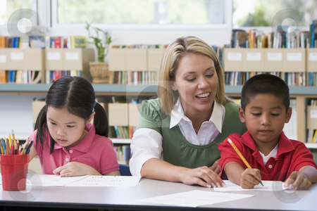 To use this stock image in your creative project, please select the size you need over to the right and click the "Add to Cart" button.
Your downloaded image will come with the Cutcaster watermark removed so don’t worry about the watermark you see on this page. Kindergarten teacher helping students with writing skills stock photo, by Monkey Business Images