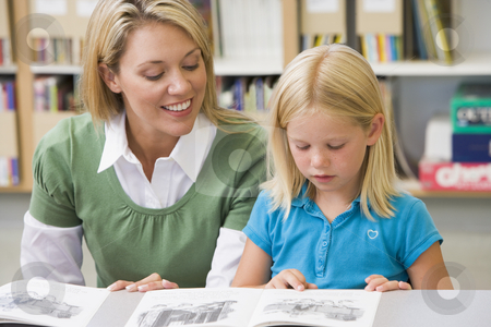 To use this stock image in your creative project, please select the size you need over to the right and click the "Add to Cart" button.
Your downloaded image will come with the Cutcaster watermark removed so don’t worry about the watermark you see on this page. Kindergarten teacher helping student with reading skills stock photo, by Monkey Business Images