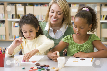 To use this stock image in your creative project, please select the size you need over to the right and click the "Add to Cart" button.
Your downloaded image will come with the Cutcaster watermark removed so don’t worry about the watermark you see on this page. Kindergarten teacher sitting with students in art class, stock photo, by Monkey Business Images