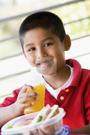 To use this stock image in your creative project, please select the size you need over to the right and click the "Add to Cart" button.
Your downloaded image will come with the Cutcaster watermark removed so don’t worry about the watermark you see on this page. Boy eating lunch at kindergarten stock photo, by Monkey Business Images