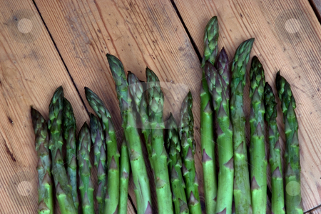 To use this stock image in your creative project, please select the size you need over to the right and click the "Add to Cart" button.
Your downloaded image will come with the Cutcaster watermark removed so don’t worry about the watermark you see on this page. New harvest stock photo, Asparagus heads on a bench in the garden by Paul Phillips
