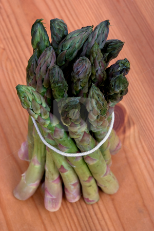 To use this stock image in your creative project, please select the size you need over to the right and click the "Add to Cart" button.
Your downloaded image will come with the Cutcaster watermark removed so don’t worry about the watermark you see on this page. Bundle of asparagus stock photo, A bundle of asparagus tied up on a wooden work surface by Paul Phillips