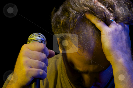To use this stock image in your creative project, please select the size you need over to the right and click the "Add to Cart" button.
Your downloaded image will come with the Cutcaster watermark removed so don’t worry about the watermark you see on this page. Passionate Vocalist & Microphone stock photo, Passionate Vocalist with Microphone on a black background. by Andy Dean