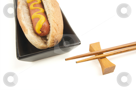 To use this stock image in your creative project, please select the size you need over to the right and click the "Add to Cart" button.
Your downloaded image will come with the Cutcaster watermark removed so don’t worry about the watermark you see on this page. Hot Dog and Chopsticks stock photo, East Meets West - Hot Dog and Chopsticks Isolated on a White Background by Andy Dean