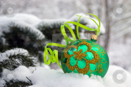 To use this stock image in your creative project, please select the size you need over to the right and click the "Add to Cart" button.
Your downloaded image will come with the Cutcaster watermark removed so don’t worry about the watermark you see on this page. Christmas-tree. stock photo, A green christmas bauble sitting in a bed of snow. by Yury Ponomarev