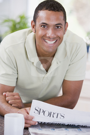 To use this stock image in your creative project, please select the size you need over to the right and click the "Add to Cart" button.
Your downloaded image will come with the Cutcaster watermark removed so don’t worry about the watermark you see on this page. Man in kitchen reading newspaper and smiling stock photo, by Monkey Business Images