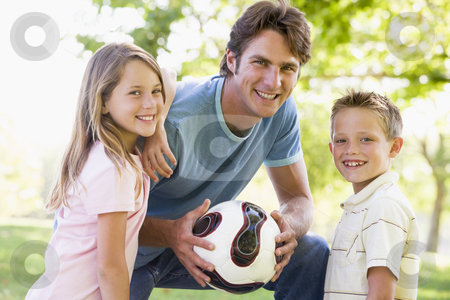 To use this stock image in your creative project, please select the size you need over to the right and click the "Add to Cart" button.
Your downloaded image will come with the Cutcaster watermark removed so don’t worry about the watermark you see on this page. Man and two young children outdoors holding volleyball and smili stock photo, by Monkey Business Images