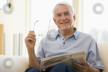 To use this stock image in your creative project, please select the size you need over to the right and click the "Add to Cart" button.
Your downloaded image will come with the Cutcaster watermark removed so don’t worry about the watermark you see on this page. Man in living room reading newspaper smiling stock photo, by Monkey Business Images