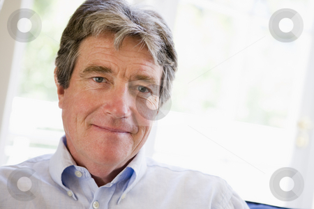 To use this stock image in your creative project, please select the size you need over to the right and click the "Add to Cart" button.
Your downloaded image will come with the Cutcaster watermark removed so don’t worry about the watermark you see on this page. Man in living room stock photo, by Monkey Business Images