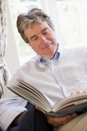 To use this stock image in your creative project, please select the size you need over to the right and click the "Add to Cart" button.
Your downloaded image will come with the Cutcaster watermark removed so don’t worry about the watermark you see on this page. Man in living room reading book smiling stock photo, by Monkey Business Images