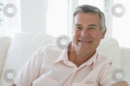 To use this stock image in your creative project, please select the size you need over to the right and click the "Add to Cart" button.
Your downloaded image will come with the Cutcaster watermark removed so don’t worry about the watermark you see on this page. Man in living room smiling stock photo, by Monkey Business Images