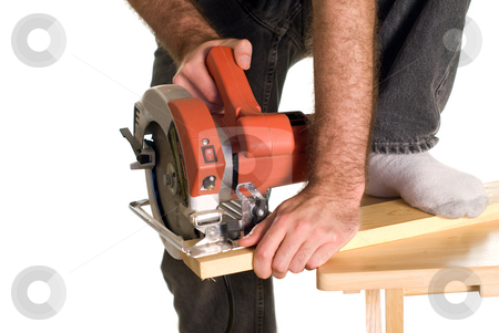 To use this stock image in your creative project, please select the size you need over to the right and click the "Add to Cart" button.
Your downloaded image will come with the Cutcaster watermark removed so don’t worry about the watermark you see on this page. Dangerous Work stock photo, A man bracing a piece of wood with his foot in order to cut a piece of lumber with a skilsaw by Richard Nelson