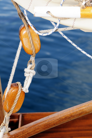 To use this stock image in your creative project, please select the size you need over to the right and click the "Add to Cart" button.
Your downloaded image will come with the Cutcaster watermark removed so don’t worry about the watermark you see on this page. Old sailing pulleys stock photo, Close-up of wooden blocks on a old-fashioned sailboat with blue sea in background by Massimiliano Leban