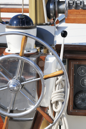 To use this stock image in your creative project, please select the size you need over to the right and click the "Add to Cart" button.
Your downloaded image will come with the Cutcaster watermark removed so don’t worry about the watermark you see on this page. Nautical instruments stock photo, Detail of a wooden sailboat deck with rudder and compass by Massimiliano Leban