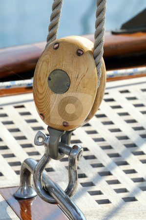 To use this stock image in your creative project, please select the size you need over to the right and click the "Add to Cart" button.
Your downloaded image will come with the Cutcaster watermark removed so don’t worry about the watermark you see on this page. Sailing block stock photo, Close-up of a wooden pulley on a sailboat by Massimiliano Leban
