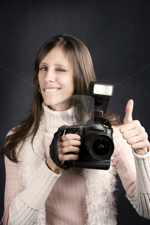 To use this stock image in your creative project, please select the size you need over to the right and click the "Add to Cart" button.
Your downloaded image will come with the Cutcaster watermark removed so don’t worry about the watermark you see on this page. Thumbs Up From a Pretty Photographer stock photo, Pretty photographer with a professional camera and flash gives Thumbs Up by Scott Griessel