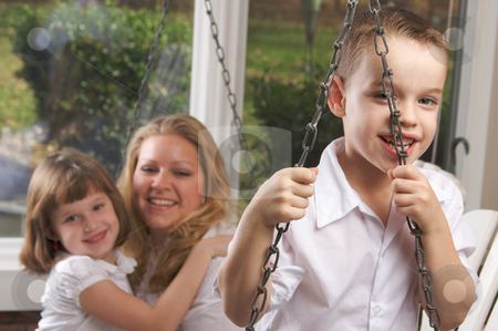 To use this stock image in your creative project, please select the size you need over to the right and click the "Add to Cart" button.
Your downloaded image will come with the Cutcaster watermark removed so don’t worry about the watermark you see on this page. Young Boy Poses with Mom and Sister stock photo, Young Boy Smiles for The Camera as His Mom and Sister Look On by Andy Dean