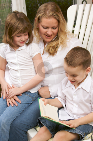 To use this stock image in your creative project, please select the size you need over to the right and click the "Add to Cart" button.
Your downloaded image will come with the Cutcaster watermark removed so don’t worry about the watermark you see on this page. Young Boy Reads to His Mother and Sister stock photo, Young Boy Reads to His Mother and Sister by Andy Dean