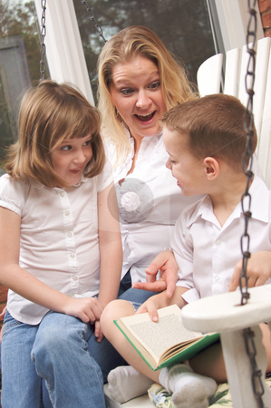 To use this stock image in your creative project, please select the size you need over to the right and click the "Add to Cart" button.
Your downloaded image will come with the Cutcaster watermark removed so don’t worry about the watermark you see on this page. Young Boy Reads to His Mother and Sister stock photo, Young Boy Reads to His Mother and Sister by Andy Dean