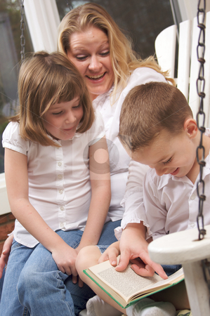 To use this stock image in your creative project, please select the size you need over to the right and click the "Add to Cart" button.
Your downloaded image will come with the Cutcaster watermark removed so don’t worry about the watermark you see on this page. Young Boy Reads to His Mother and Sister stock photo, Young Boy Reads to His Mother and Sister by Andy Dean