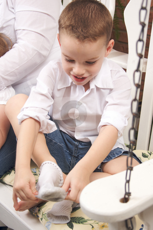 To use this stock image in your creative project, please select the size you need over to the right and click the "Add to Cart" button.
Your downloaded image will come with the Cutcaster watermark removed so don’t worry about the watermark you see on this page. Adorable Young Boy Getting Socks On stock photo, Adorable Young Boy Getting Dressed Putting His Socks On by Andy Dean