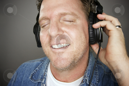 To use this stock image in your creative project, please select the size you need over to the right and click the "Add to Cart" button.
Your downloaded image will come with the Cutcaster watermark removed so don’t worry about the watermark you see on this page. Man Wearing Headphones stock photo, Man Wearing Headphones Enjoying His Music on a Grey Background. by Andy Dean