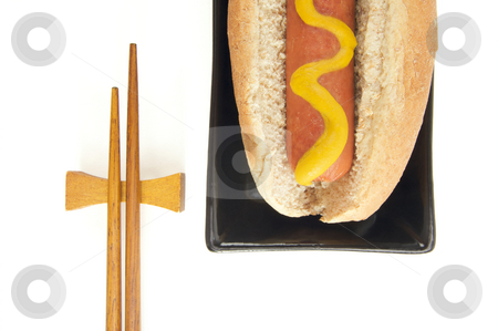 To use this stock image in your creative project, please select the size you need over to the right and click the "Add to Cart" button.
Your downloaded image will come with the Cutcaster watermark removed so don’t worry about the watermark you see on this page. Hot Dog and Chopsticks stock photo, East Meets West - Hot Dog and Chopsticks Isolated on a White Background by Andy Dean
