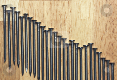 To use this stock image in your creative project, please select the size you need over to the right and click the "Add to Cart" button.
Your downloaded image will come with the Cutcaster watermark removed so don’t worry about the watermark you see on this page. Declining Graph of Nails stock photo, Declining Graph of Nails on a Wood Background. by Andy Dean
