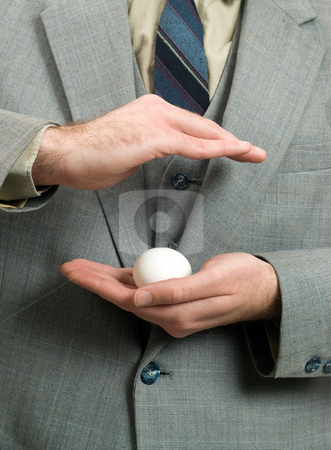 To use this stock image in your creative project, please select the size you need over to the right and click the "Add to Cart" button.
Your downloaded image will come with the Cutcaster watermark removed so don’t worry about the watermark you see on this page. New Business stock photo, Concept of a businessman trying to protect his new business by Richard Nelson