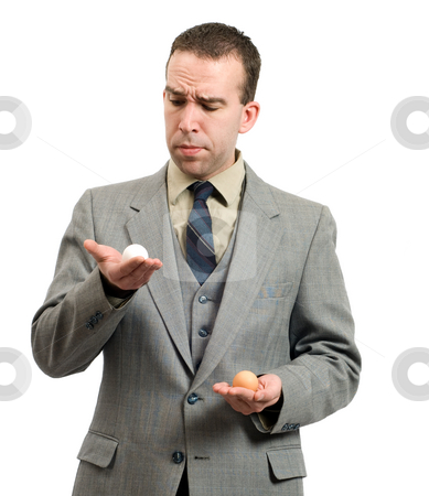 To use this stock image in your creative project, please select the size you need over to the right and click the "Add to Cart" button.
Your downloaded image will come with the Cutcaster watermark removed so don’t worry about the watermark you see on this page. Comparing Eggs stock photo, Young businessman comparing a white egg and a brown egg; symbolic for different business plans by Richard Nelson