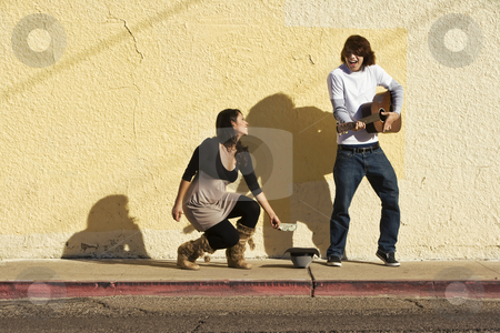 To use this stock image in your creative project, please select the size you need over to the right and click the "Add to Cart" button.
Your downloaded image will come with the Cutcaster watermark removed so don’t worry about the watermark you see on this page. Musician on Sidewalk and Woman Pedestrian stock photo, Musician on Sidewalk and Woman Pedestrian by Scott Griessel
