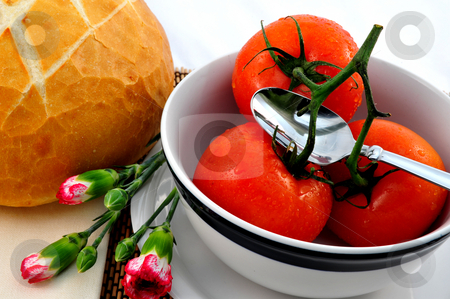 To use this stock image in your creative project, please select the size you need over to the right and click the "Add to Cart" button.
Your downloaded image will come with the Cutcaster watermark removed so don’t worry about the watermark you see on this page. Tomato Soup stock photo, Fresh tomatoes ready for making tomato soup in a white bowl with a loaf of sourdough bread and carnation flowers by Lynn Bendickson