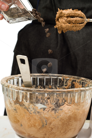 To use this stock image in your creative project, please select the size you need over to the right and click the "Add to Cart" button.
Your downloaded image will come with the Cutcaster watermark removed so don’t worry about the watermark you see on this page. Adding Chocolate Chips stock photo, Someone adding chocolate chips to the cookie batter by Richard Nelson