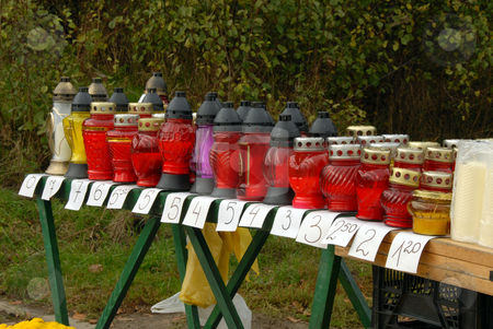 To use this stock image in your creative project, please select the size you need over to the right and click the "Add to Cart" button.
Your downloaded image will come with the Cutcaster watermark removed so don’t worry about the watermark you see on this page. Cemetery candles stock photo, Candles in colors staying in the autumn shoop by Joanna Szycik