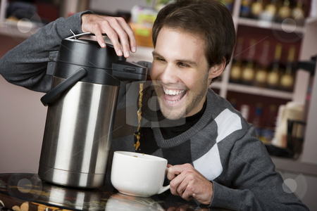 To use this stock image in your creative project, please select the size you need over to the right and click the "Add to Cart" button.
Your downloaded image will come with the Cutcaster watermark removed so don’t worry about the watermark you see on this page. Coffee Crazed Young Man stock photo, Young man crazily pouring coffee from a thermos in a cafe by Scott Griessel