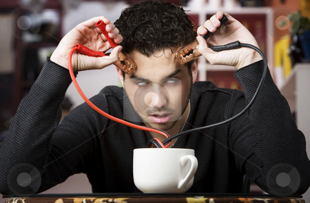 To use this stock image in your creative project, please select the size you need over to the right and click the "Add to Cart" button.
Your downloaded image will come with the Cutcaster watermark removed so don’t worry about the watermark you see on this page. Coffee Jolt stock photo, Young man holding jumper cables coming out of coffee mug by Scott Griessel
