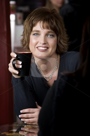 To use this stock image in your creative project, please select the size you need over to the right and click the "Add to Cart" button.
Your downloaded image will come with the Cutcaster watermark removed so don’t worry about the watermark you see on this page. Portrait of Woman with Friend in Coffee House stock photo, Pretty adult woman with friend in a coffee house by Scott Griessel