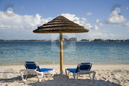 To use this stock image in your creative project, please select the size you need over to the right and click the "Add to Cart" button.
Your downloaded image will come with the Cutcaster watermark removed so don’t worry about the watermark you see on this page. Beach hut and chairs on tropical island stock photo, Small beach hut on tropical shoreline with chairs underneath. by Robert Ranson