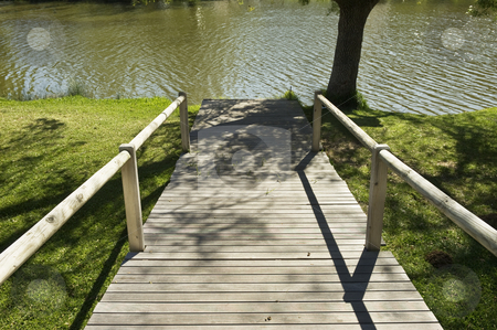 To use this stock image in your creative project, please select the size you need over to the right and click the "Add to Cart" button.
Your downloaded image will come with the Cutcaster watermark removed so don’t worry about the watermark you see on this page. Wooden pathway in a natural park stock photo, Wooden pathway leading to the river in a natural park by Manuel Ribeiro