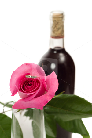 To use this stock image in your creative project, please select the size you need over to the right and click the "Add to Cart" button.
Your downloaded image will come with the Cutcaster watermark removed so don’t worry about the watermark you see on this page. Hidden Ring In Rose stock photo, Closeup view of a ring hidden inside a rose, with an out of focus bottle of wine in the background, isolated against a white background by Richard Nelson