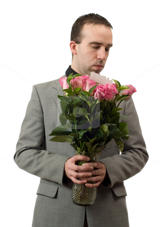To use this stock image in your creative project, please select the size you need over to the right and click the "Add to Cart" button.
Your downloaded image will come with the Cutcaster watermark removed so don’t worry about the watermark you see on this page. Man Smelling Roses stock photo, A young man wearing a formal suit is smelling some roses in a vase, isolated against a white background by Richard Nelson
