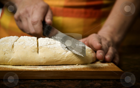 To use this stock image in your creative project, please select the size you need over to the right and click the "Add to Cart" button.
Your downloaded image will come with the Cutcaster watermark removed so don’t worry about the watermark you see on this page. Adding cut to unbaked bread dough stock photo, Adding cut to unbaked bread dough with serrated knife by Scott Griessel