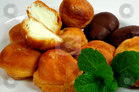 To use this stock image in your creative project, please select the size you need over to the right and click the "Add to Cart" button.
Your downloaded image will come with the Cutcaster watermark removed so don’t worry about the watermark you see on this page. Cream Puff Closeup stock photo, Two different kinds of cream puffs on a saucer with mint leaves by Lynn Bendickson