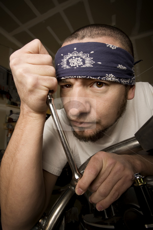 To use this stock image in your creative project, please select the size you need over to the right and click the "Add to Cart" button.
Your downloaded image will come with the Cutcaster watermark removed so don’t worry about the watermark you see on this page. Hispanic Mechanic stock photo, Hispanic mechanic working on a chopper style motorcycle by Scott Griessel