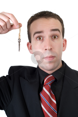 To use this stock image in your creative project, please select the size you need over to the right and click the "Add to Cart" button.
Your downloaded image will come with the Cutcaster watermark removed so don’t worry about the watermark you see on this page. Businessman Holding Key stock photo, A young businessman wearing a suit, holding an old key, isolated against a white background by Richard Nelson