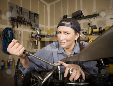 To use this stock image in your creative project, please select the size you need over to the right and click the "Add to Cart" button.
Your downloaded image will come with the Cutcaster watermark removed so don’t worry about the watermark you see on this page. Female Hispanic Mechanic stock photo, Female Hispanic mechanic working on a chopper style motorcycle by Scott Griessel