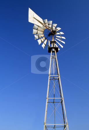 To use this stock image in your creative project, please select the size you need over to the right and click the "Add to Cart" button.
Your downloaded image will come with the Cutcaster watermark removed so don’t worry about the watermark you see on this page. Irrigation windmill stock photo, An irrigation wind pump against a blue sky by Paul Phillips