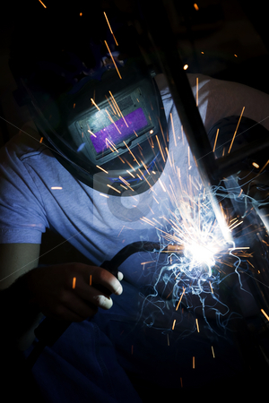 To use this stock image in your creative project, please select the size you need over to the right and click the "Add to Cart" button.
Your downloaded image will come with the Cutcaster watermark removed so don’t worry about the watermark you see on this page. Welder working on motorcycle stock photo, Welder working on the metal fork of a motorcycle by Scott Griessel