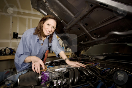 To use this stock image in your creative project, please select the size you need over to the right and click the "Add to Cart" button.
Your downloaded image will come with the Cutcaster watermark removed so don’t worry about the watermark you see on this page. Female Hispanic Mechanic stock photo, Female Hispanic mechanic working on a car engine by Scott Griessel